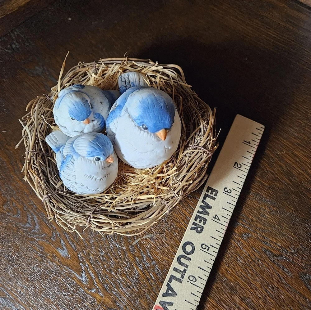 Fat blue bird mama and babies on nest figurine.